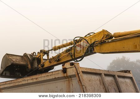 Pouring the muddy soil in to the container.
