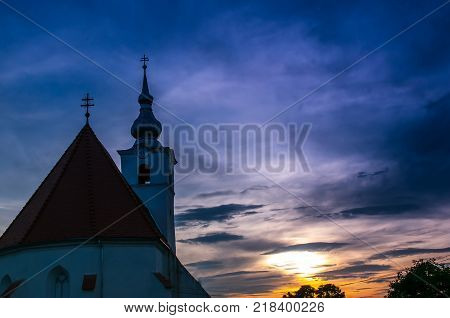 Catholic church on autumn sunset in a small village in Romania