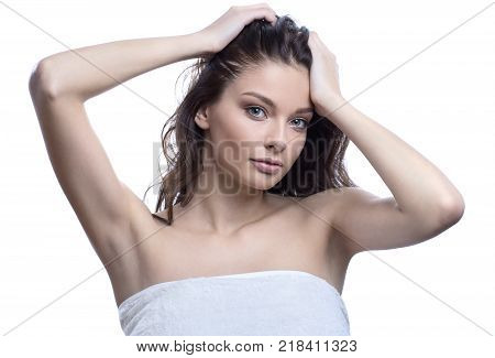 Beautiful girl with healthy brown hair. Beautiful brunette woman touching her long hair. SPA concept. Hair cosmetics, haircare. Isolated on white background.