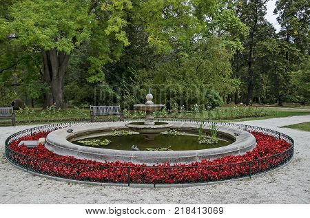 Beautiful autumnal venerable forest with fountain and flower in National monument of landscape architecture Park museum Vrana in former time royal palace on the outskirts of Sofia, Bulgaria, Europe
