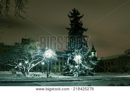 Snowy evening landscape of the city square.