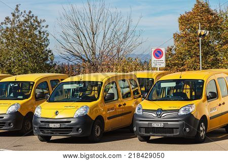 Andelfingen, Switzerland - 17 October, 2017: parked cars of Swiss Post. Swiss Post is the national postal service of Switzerland, being a public company owned by the Swiss Confederation.