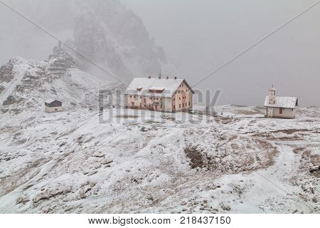 Tre Cime di Lavaredo in beautiful surroundings in the Dolomites at foggy winter weather in Italy Europe (Drei Zinnen)