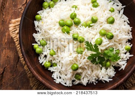 Basmati Rice Pilaf or pulav with Peas, or vegetable rice using green peas also known as matar pulav, served with plain dal