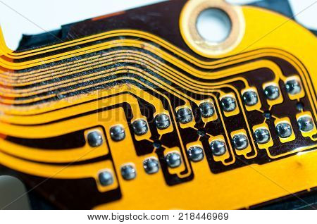 Yellow circuit board on computer parts close up shot.