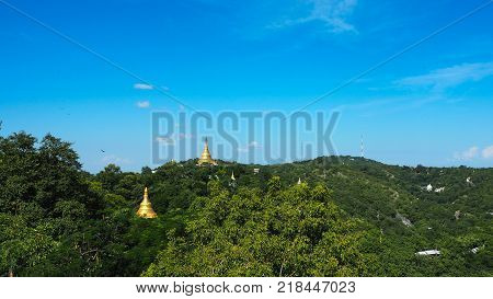 High angle view of multiple temples and pagodas on the mountains with Irrawaddy river in the background from sagaing hill, Sagaing region of Myanmar.