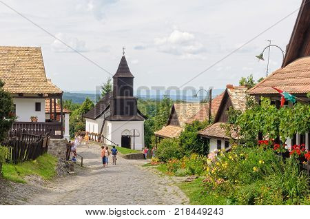 Visitors stroll along the Kossuth Street in the UNESCO World Heritage village - Holloko, Hungary, 13 July 2011