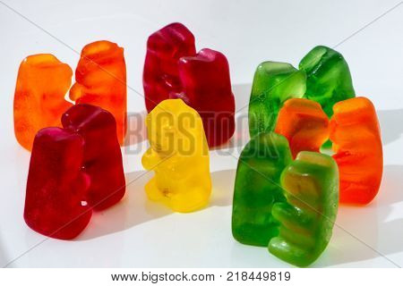 closeup shoot of the color pairs of gummy bears and one lonely bear