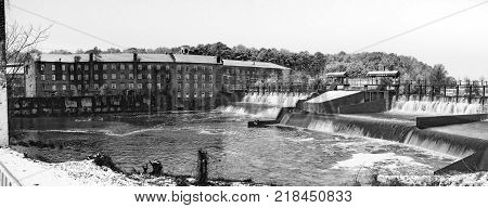 Prattville Alabama USA - December 9 2017: Historic Pratt Cotton Gin Company and spillway in downtown Prattville after a rare snow in Alabama.