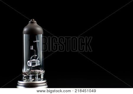 Broken headlight bulb isolated on black background