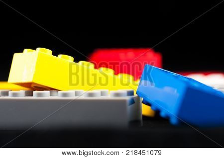 Colorful play construction bricks close up shot.