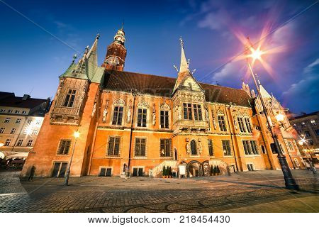 Colorful evening scene on Wroclaw Market Square with Town Hall. Sunset in historical capital of Silesia Poland Europe. Artistic style post processed photo.