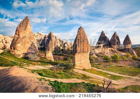 Colorful spring scene in Cappadocia. Evening in the neighborhood of Red Rose valley in April. Cavusin village located district of Nevsehir Province in the Central Anatolia Region of Turkey Asia.