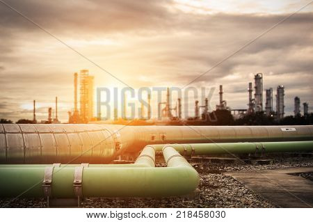pipe line connection in oil refinery,steel long pipes in crude oil factory during sunset