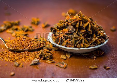 Close up of star aniseed,Illicium verum in a plate with its powder.