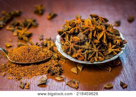 Close up of star aniseed,Illicium verum in a plate with its powder.