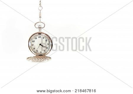Old, hanging pocket watch isolated on white background.