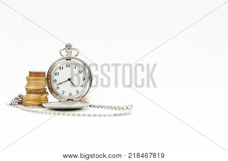 Old pocket watch , coin tower, time is money conceptual image isolated on white.