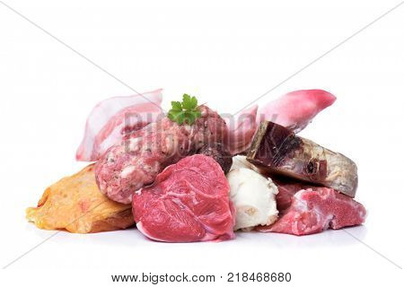 closeup of some uncooked pieces and products of chicken, beef and pork meat to prepare escudella, a soup typical of Catalonia, Spain, on a white background