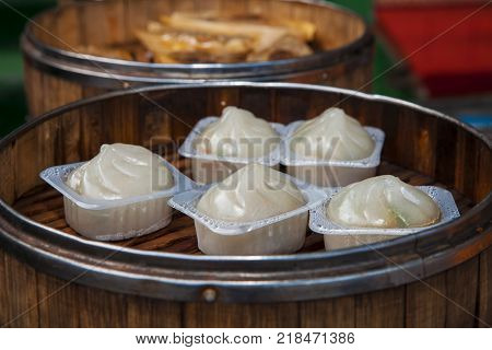 Street food booth selling Chinese specialty Steamed Dumplings in Beijing, China
