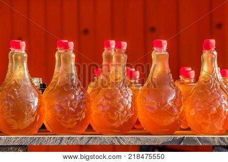 Homemade mead in various jars at traditional Russian fair