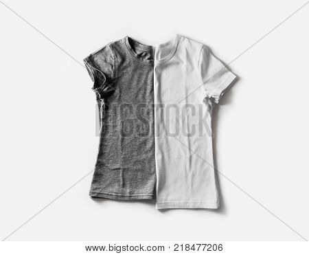 Two blank white and gray t-shirts. Tshirt mockup for placing your design or logo. Flat lay.