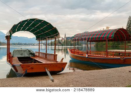 Lake Bled and the island with the church and traditional wooden Pletna at autumn in Slovenia