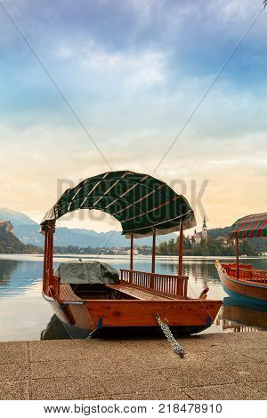 Lake Bled and the island with the church and traditional wooden Pletna at autumn in Slovenia