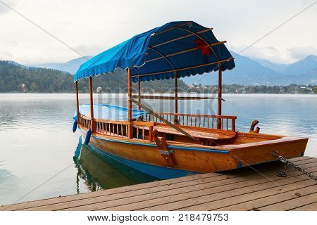 Lake Bled and traditional wooden Pletna at autumn in Slovenia