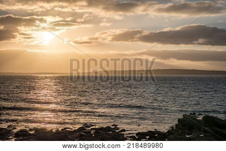 Sunset over Stroma, Scotland. The setting sun over the island of Stroma off the most notherly point of the Scottish mainland.