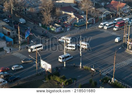 CHISINAU MOLDOVA - DECEMBER 21 2015: Minibuses public transport mode are crossing the street in Chisinau at dusk.