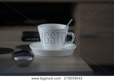 A cup of coffee with a spoon.