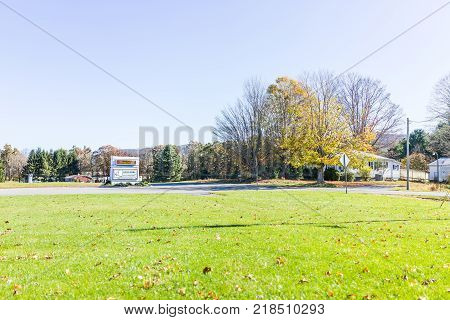 Green Bank USA - October 18 2017: Sign for Green Bank radio Telescope visitor's center entrance by road in autumn with meadow grass field in West Virginia