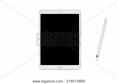 Mockup tablet computer and pencil isolated on white background, flatlay on a white wooden background, with place for your text. Flat lay, top view photo mock up.