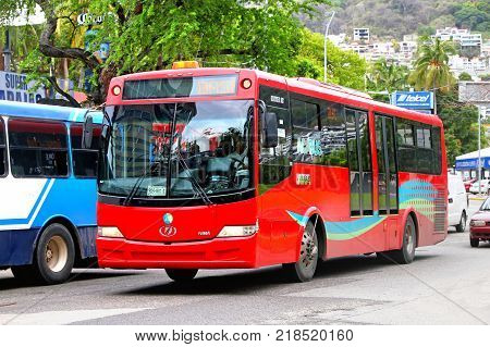 Acapulco Mexico - May 30 2017: Red urban bus Dina Linner 12 in the city street.