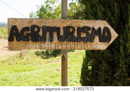 Handmade wooden agriturismo sign in Tuscany - agritourism is a typical concept of bed and breakfast in a farming environment in Italy.