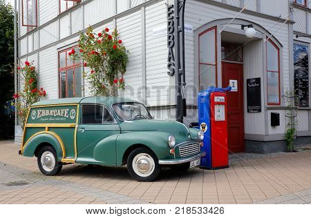 Borgholm Sweden - August 22 2017: A green Morris Minor 1000 of the 1965 model parked outside the STF hostel and restaurant Ebbas at the street Storgatan.