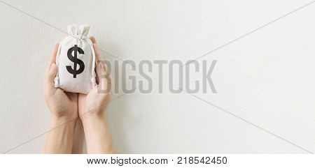 Save money and investment concept Hand holding money bag with space for your text