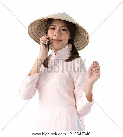 beautiful woman in pink dress and vietnam hat holding smartphone. isolated background with clipping path.