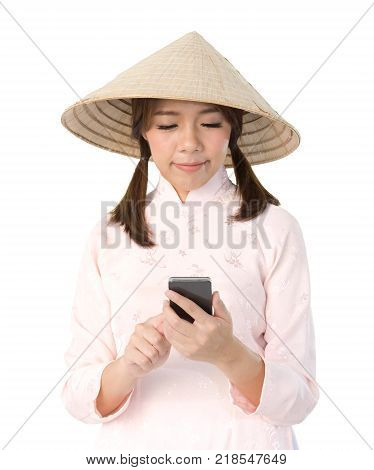 beautiful woman in pink dress and vietnam hat holding smartphone. isolated background with clipping path.