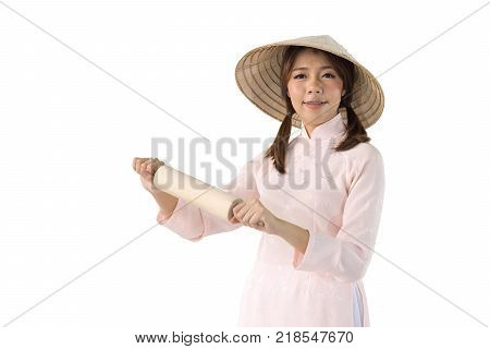beautiful woman in pink dress and vietnam hat holding rolling pin. isolated background with clipping path.
