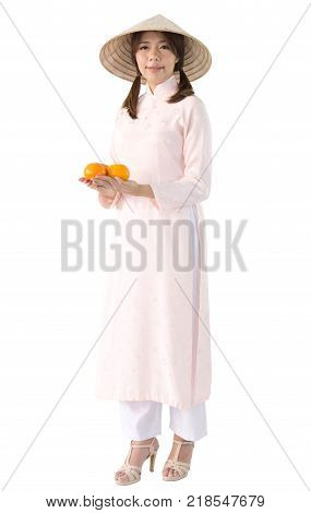 beautiful woman in pink dress and vietnam hat holding orange. isolated background with clipping path.