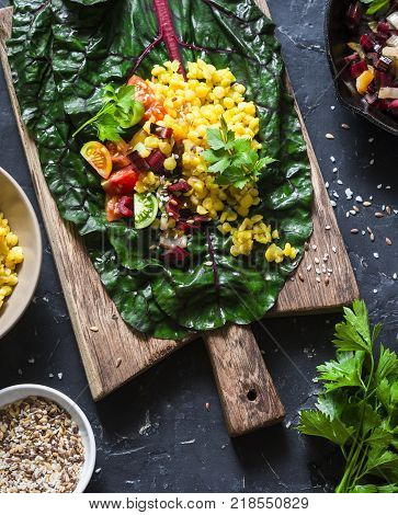 Ingredients for vegetarian chard packets. Chard leaves stuffed with turmeric lentils and vegetables. Vegetarian healthy food concept