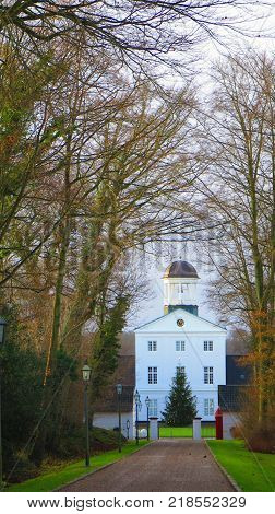Christmas tree in front of large building at end of long drive in Graasten Southern Denmark