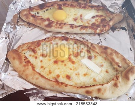 Adjarian khachapuri, open bread stuffed with cheese and egg yolk. Khachapuri is a traditional dish of Georgian cuisine.