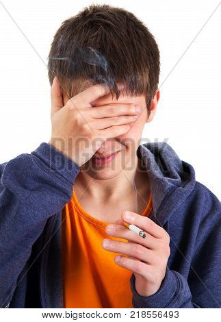 Young Man with a Cigarette hide his Face on the White Background