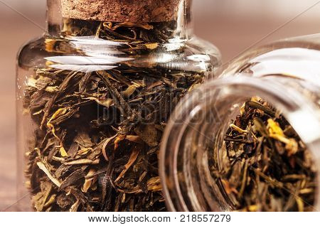 Two tea jars with herbal tea . Studio shot
