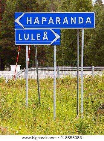 Signpost with direction to the two Swedish towns Haparanda and Lulea.