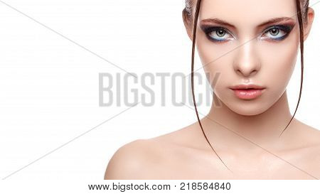 Half-face portrait of beautiful sensitive woman with fresh clean skin wet effect on her face and body high fashion and beauty portrait creative makeup theme strobing or highlighting makeup
