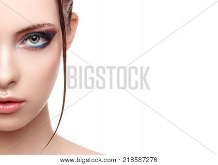 Close up half face portrait of model with glamorous makeup wet effect on her face and body high fashion and beauty creative makeup theme strobing or highlighting makeup copy space your text here